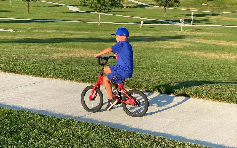 boy riding a bike on a walking path at Mallard Park