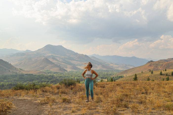 woman standing on mountain with Sun Valley in background