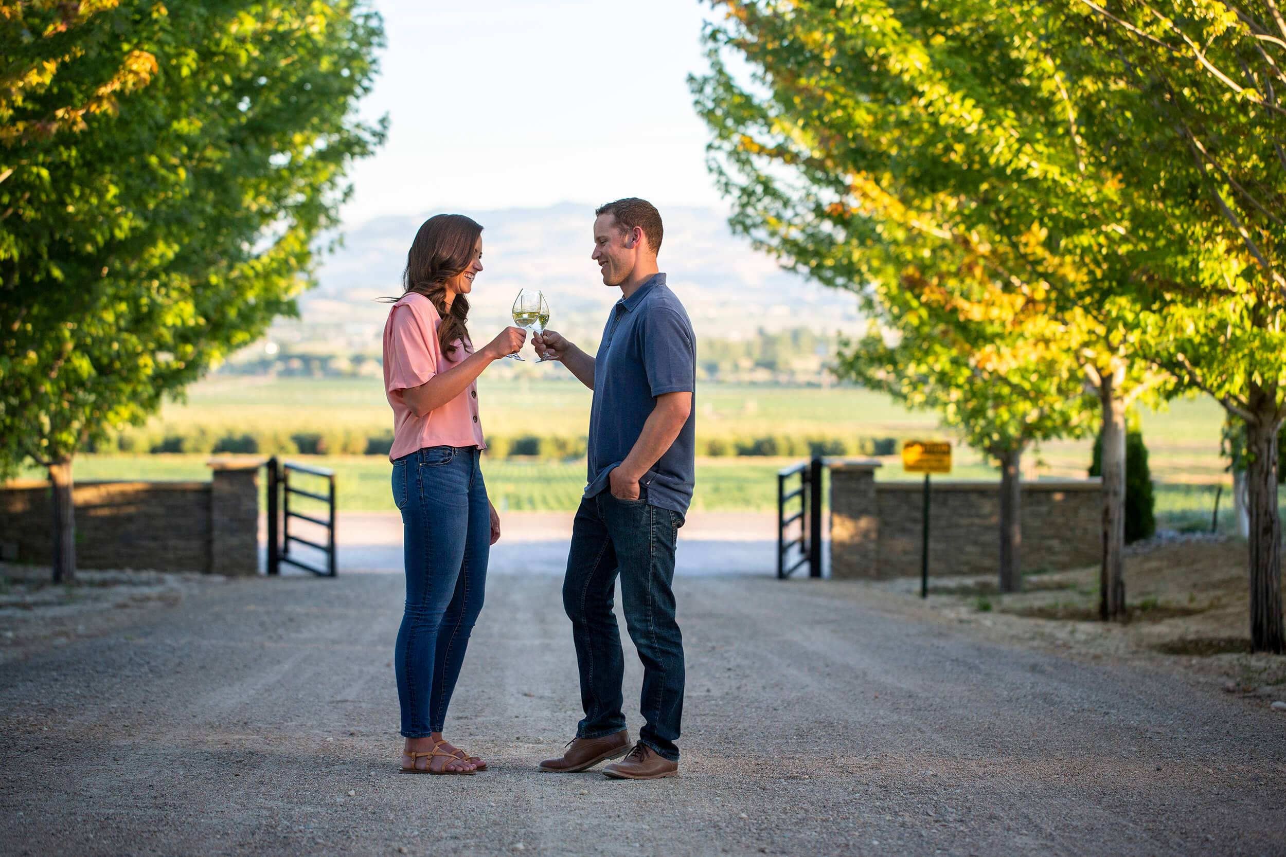 A couple clinking glasses of wine at Koenig Vineyards.