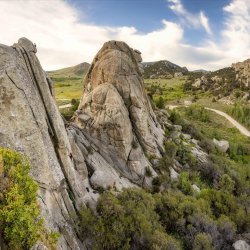 View of giant rocks surrounded by shrubs at City of Rocks National Reserve.