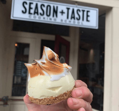 person holding dessert under season and taste sign