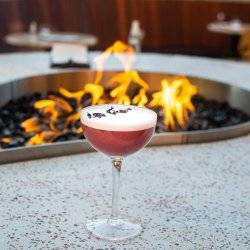 A cocktail from Ochos in Boise, Idaho, by an outdoor firepit.