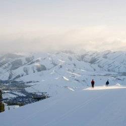 wide mountain shot of people skiing