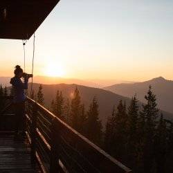 woman standing outside deck of fire lookout