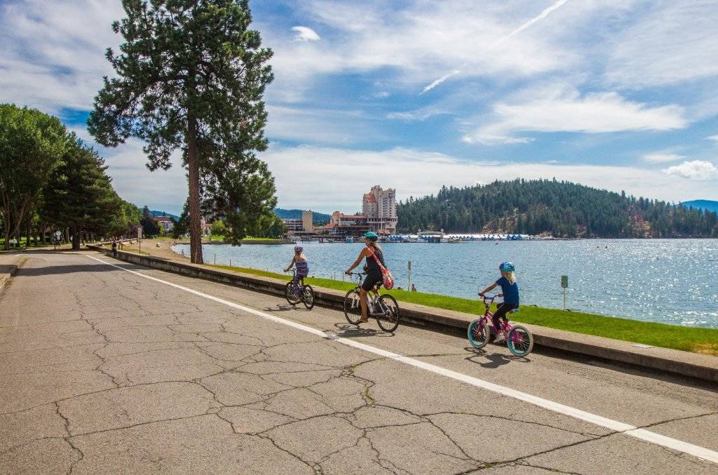 mom and two kids riding bikes along Lake Coeur d'Alene