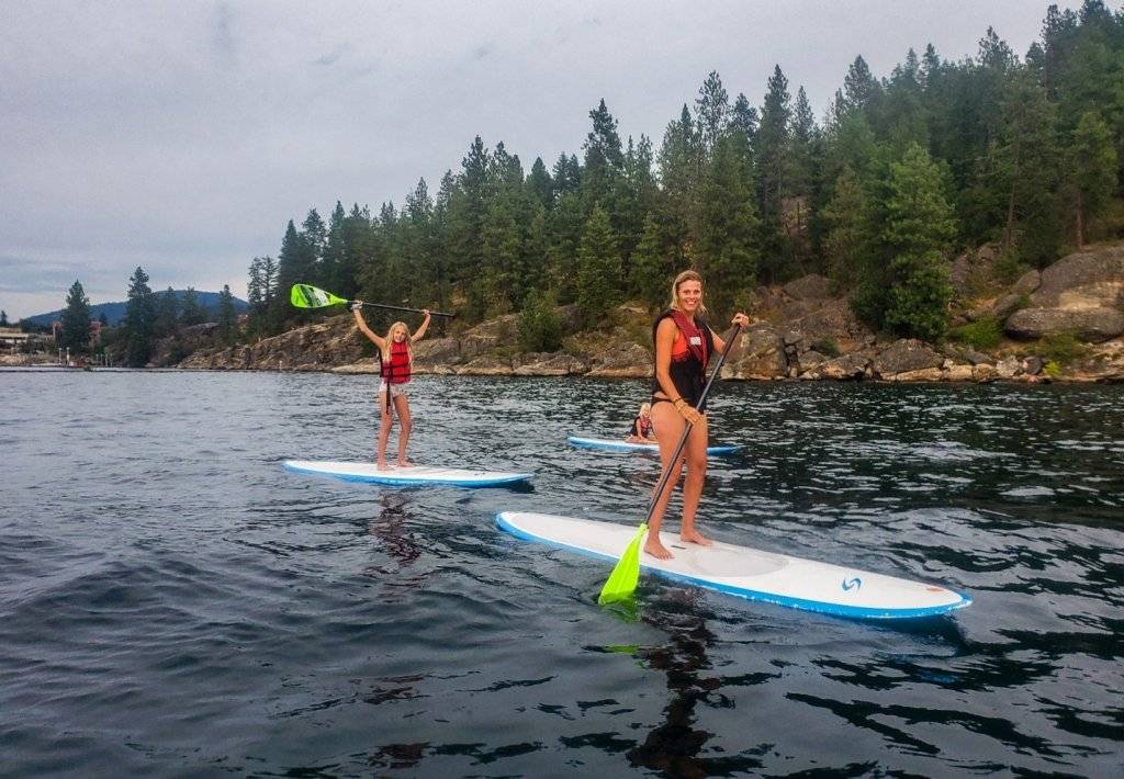 mom and daughter on standup paddleboads on lake coeur d'alene