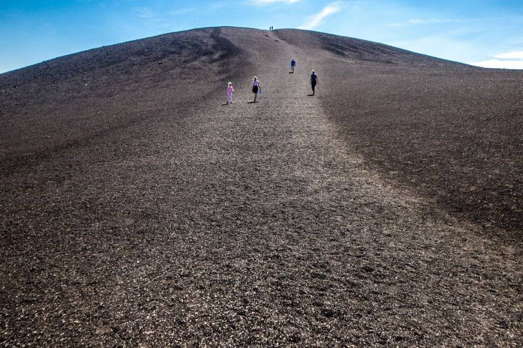 people running up hill at craters of the moon