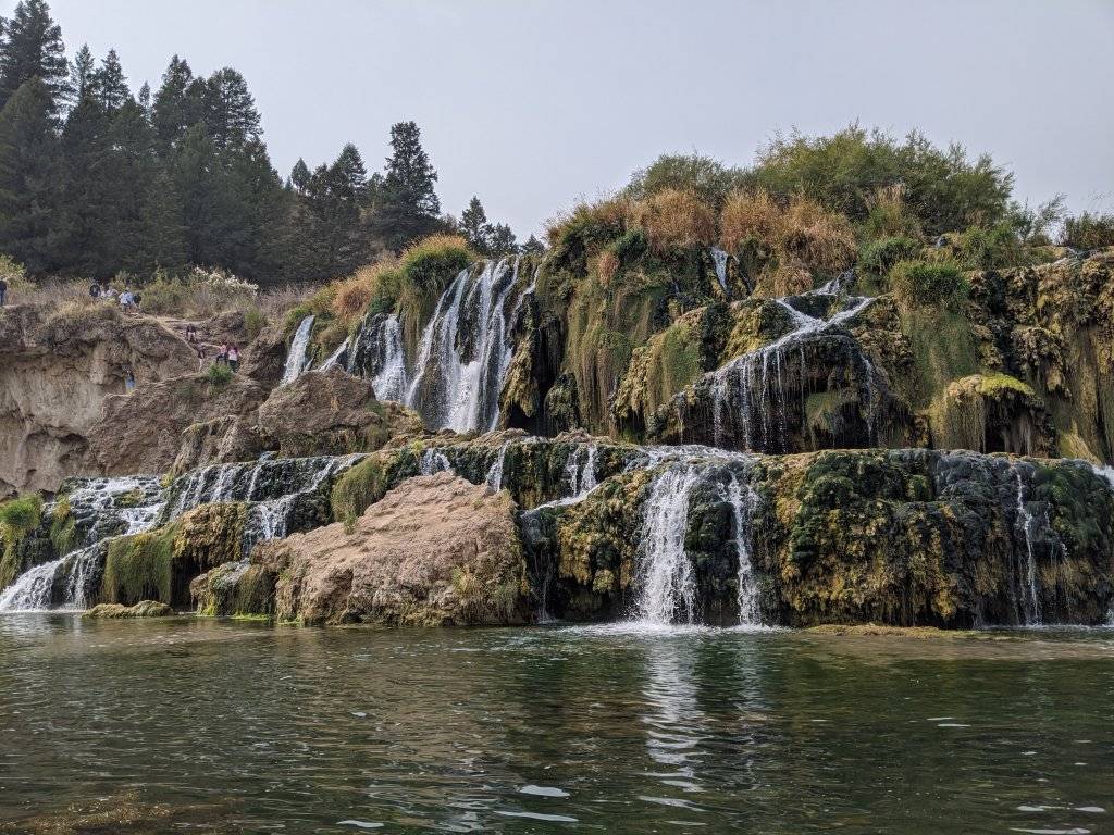 scenic waterfall as seen from adjacent river