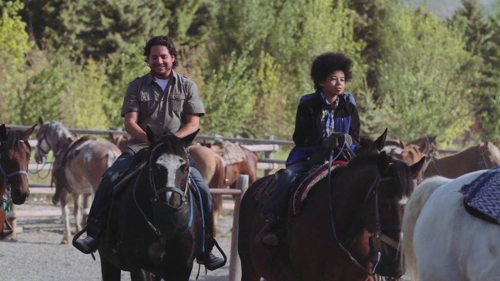 A man and child go horseback riding at the Sun Valley Stables in Sun Valley Idaho