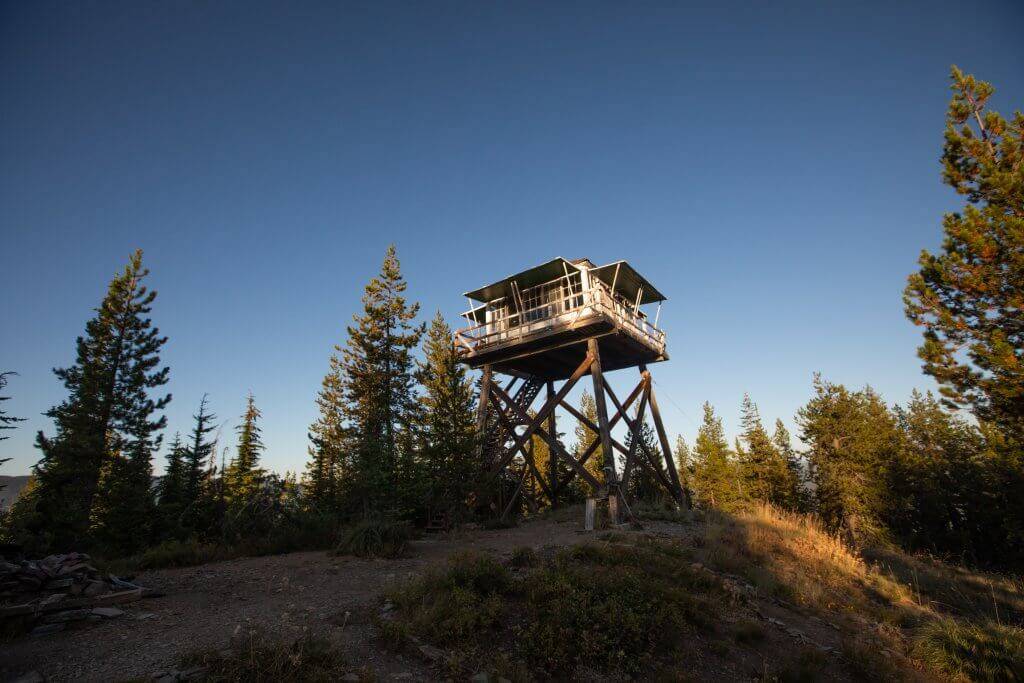 exterior of fire lookout with two women standing at base