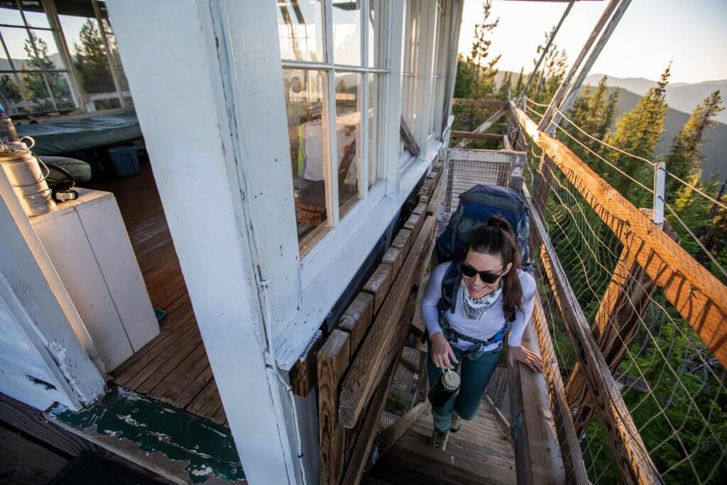 woman climbing steps of fire lookout