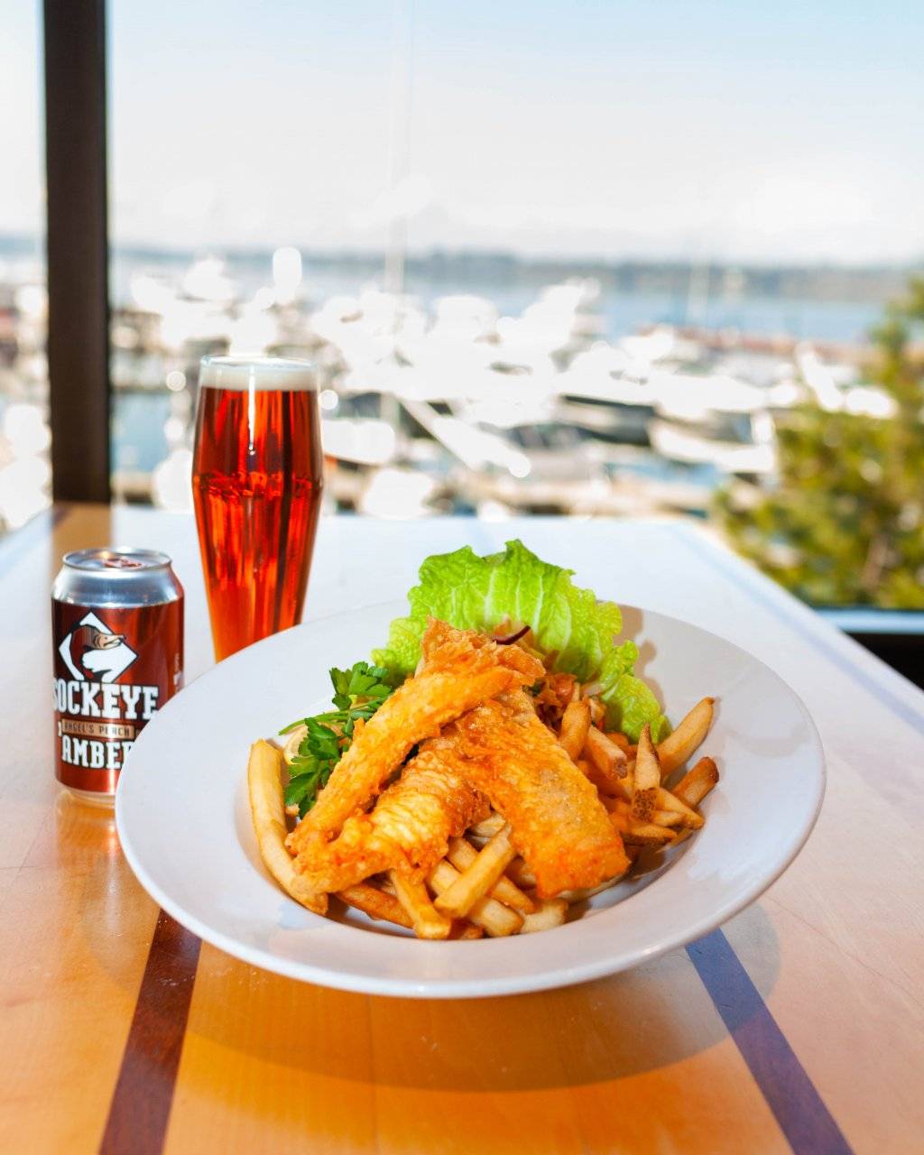 salmon and chips on plate with side of beer