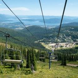 chairlift in summer with lake in distance Schweitzer Summer Activities