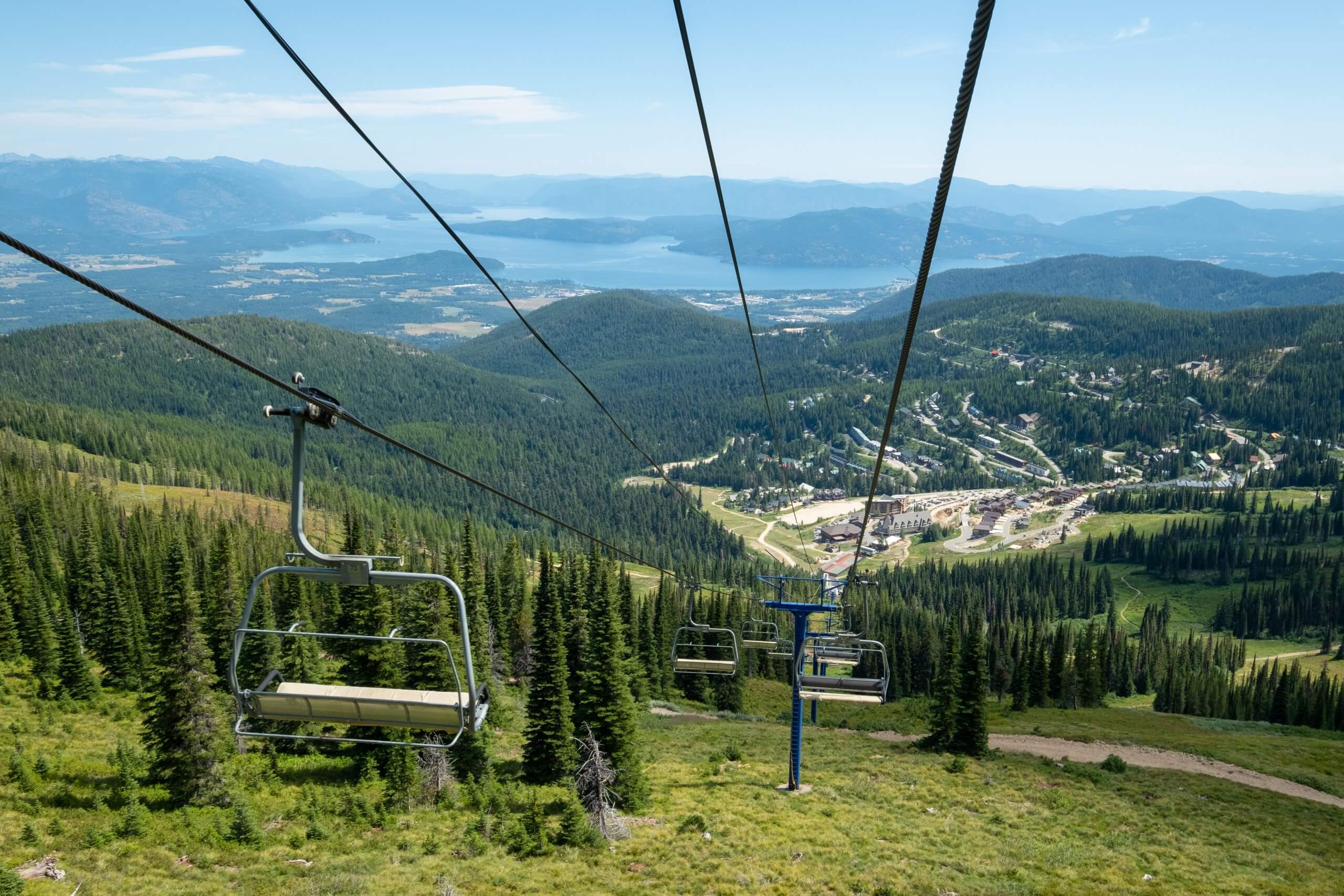 chairlift in summer with lake in distance Schweitzer Summer Activities