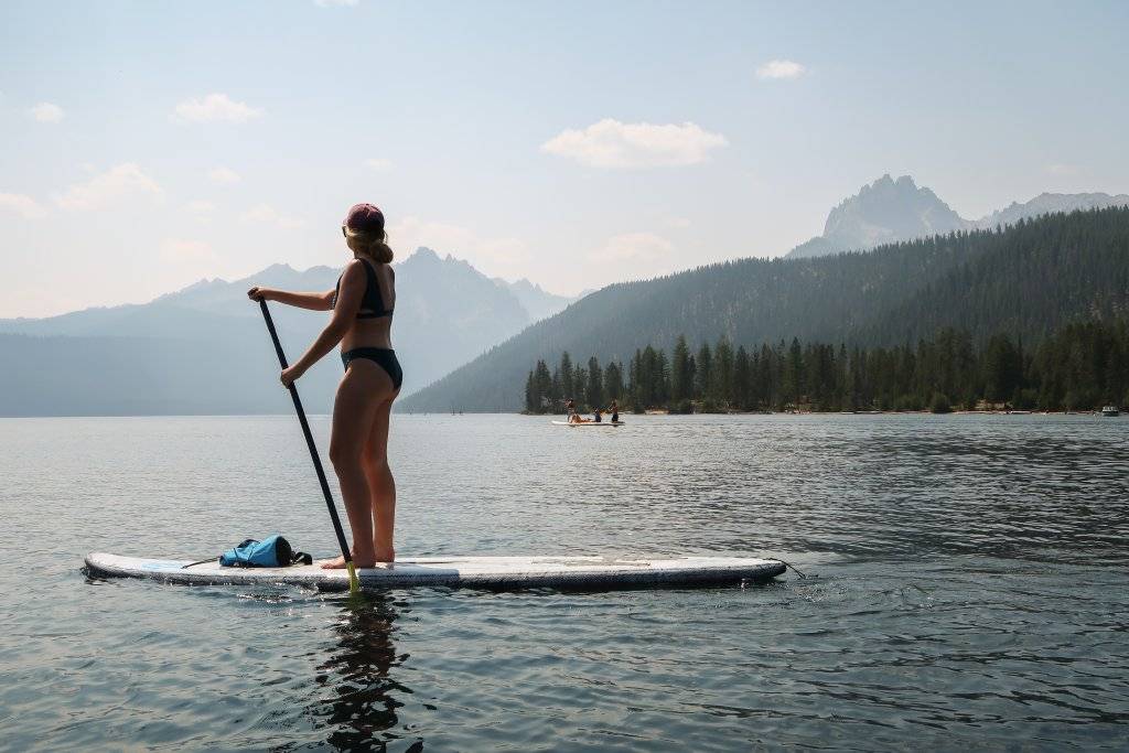 woman on paddle board on lake