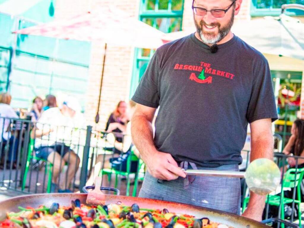 man cooking paella