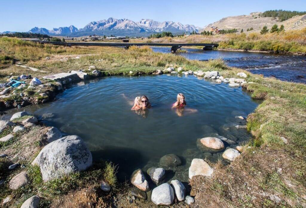 mom and daughters in natural hot spring