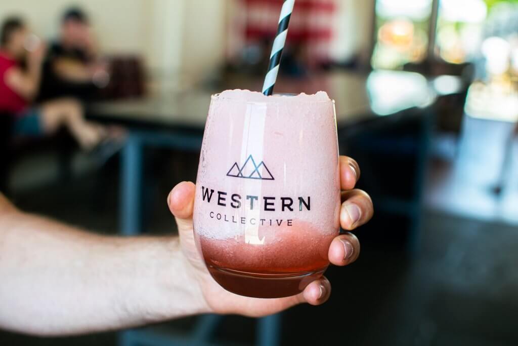 person holding glass of frose