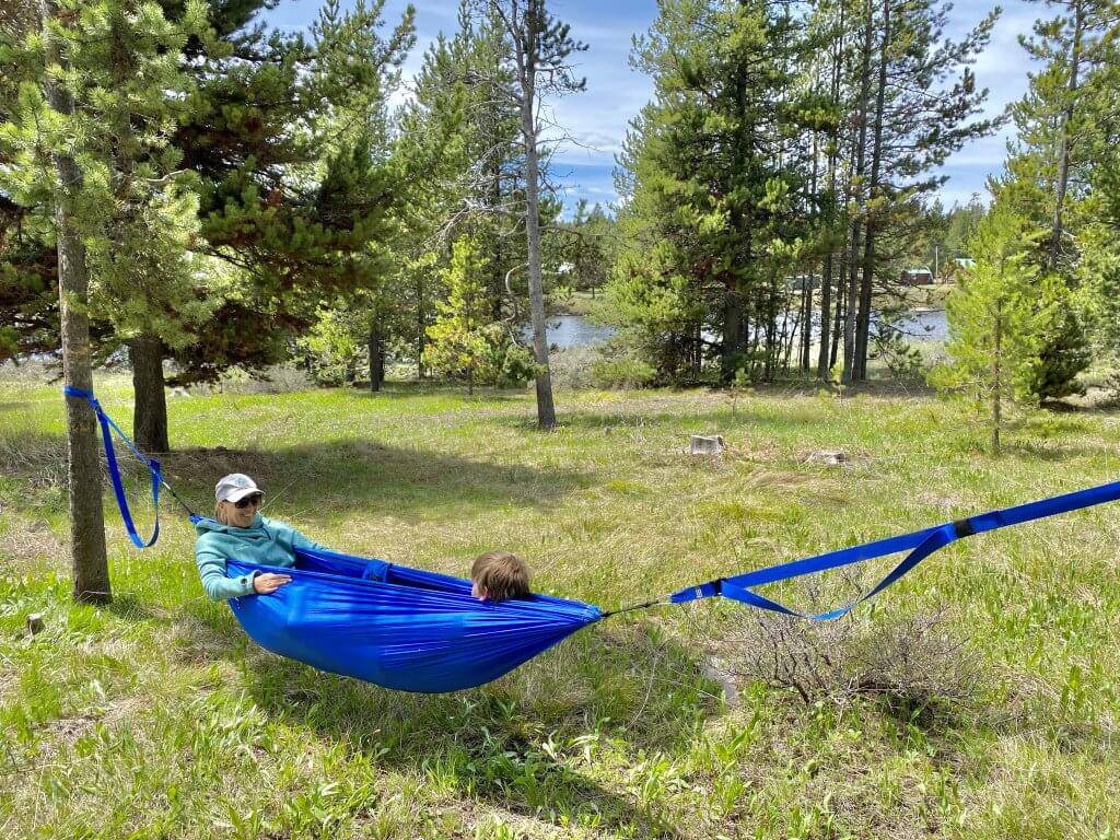 mom and child in hammock with river in background