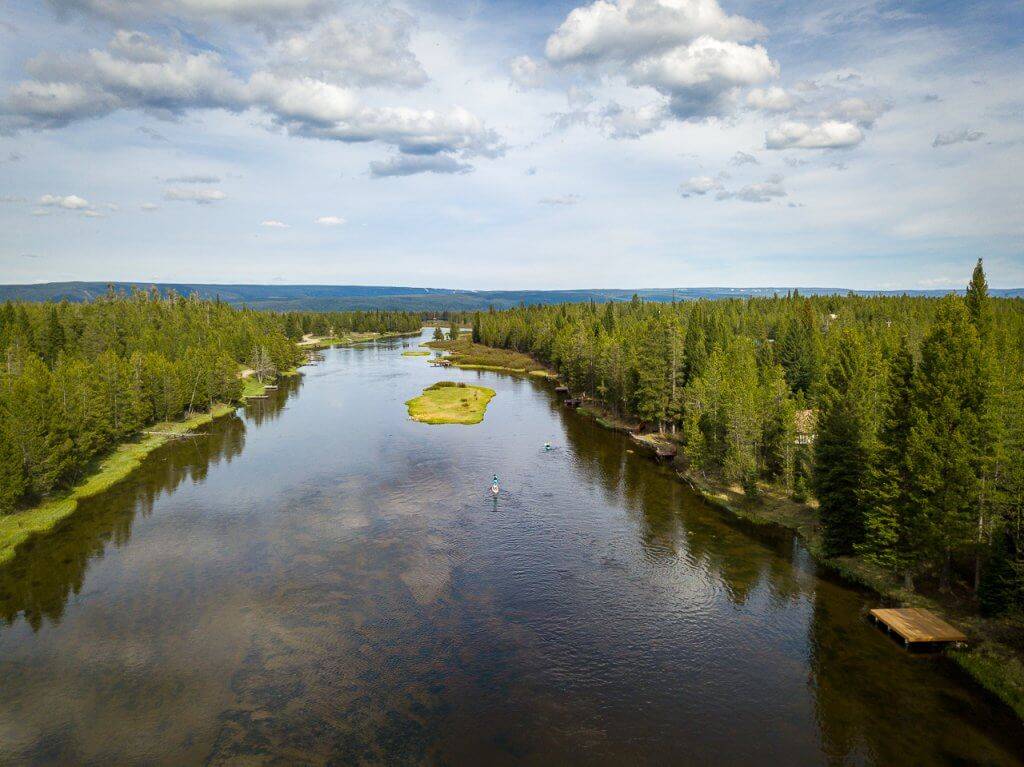 aerial photo of person paddle boarding on river