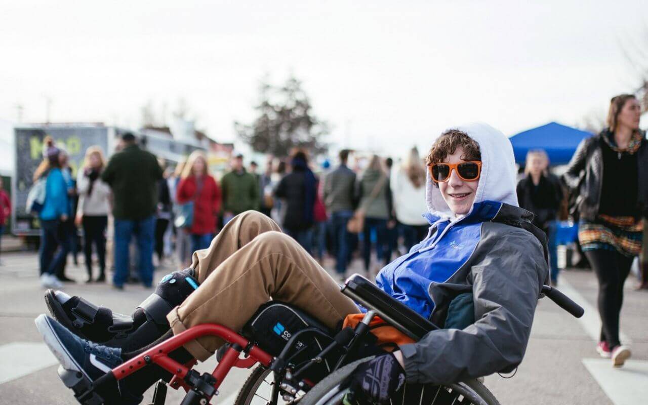 man in wheelchair doing wheelie