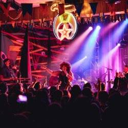 woman on stage singing to a crowd