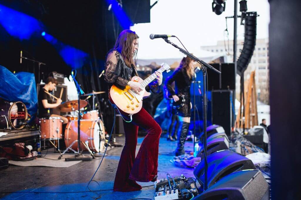 woman with guitar singing