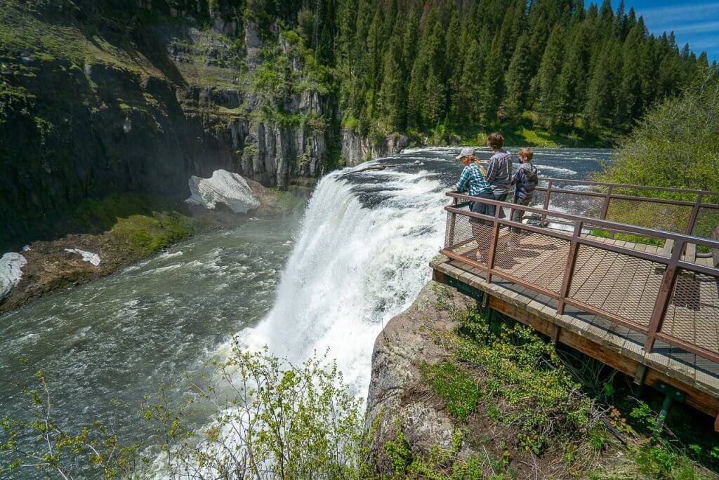 three people at waterfall overlook