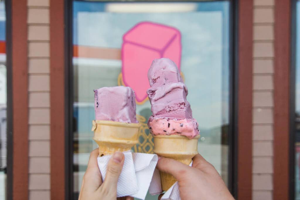 people holding ice cream cones with square scoops of ice cream