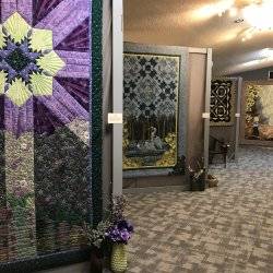 Colorful quilts displayed in a museum.