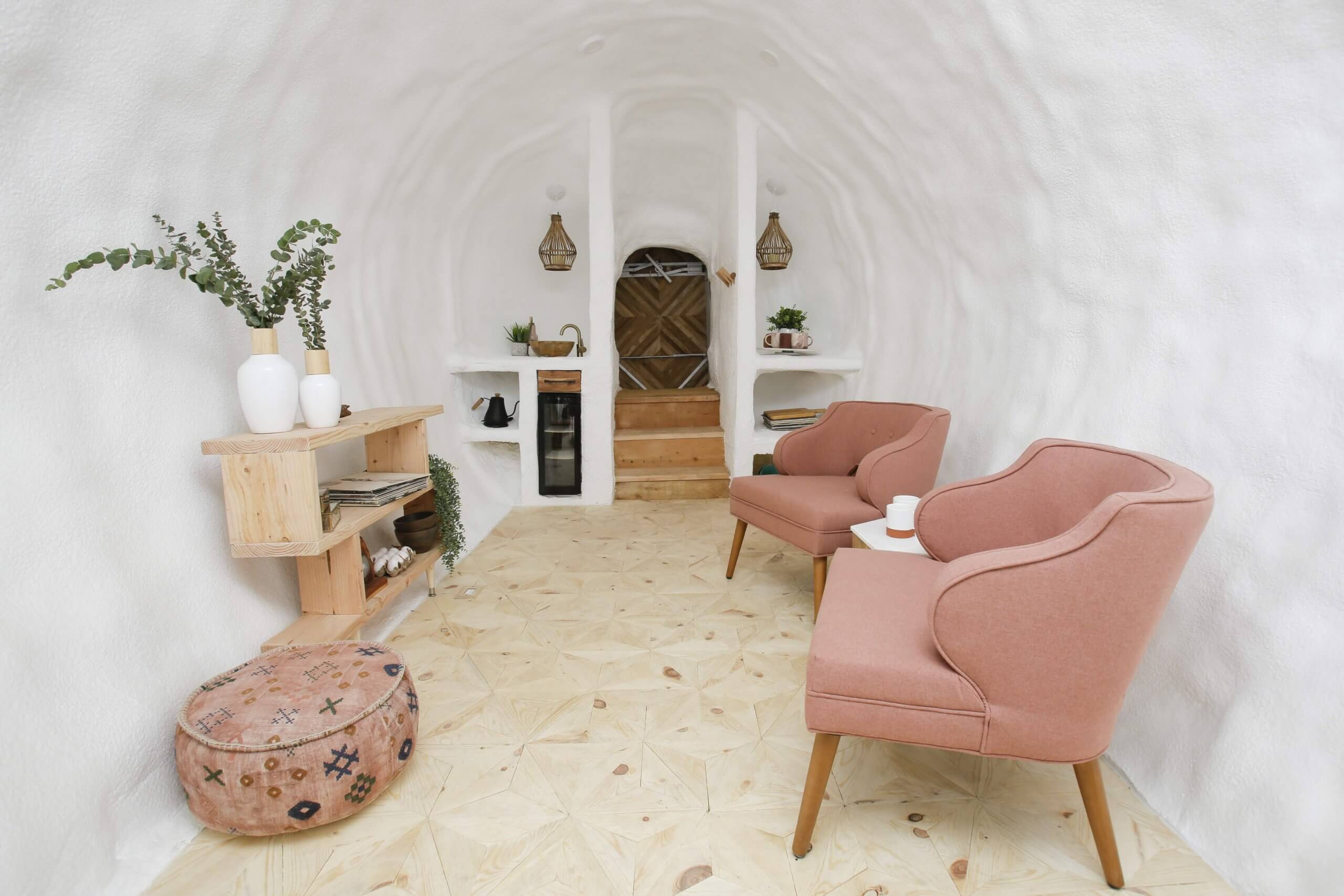 Cozy lounge area with pink furniture reclining in a clean, open space inside the Big Idaho Potato Hotel in Boise, Idaho.