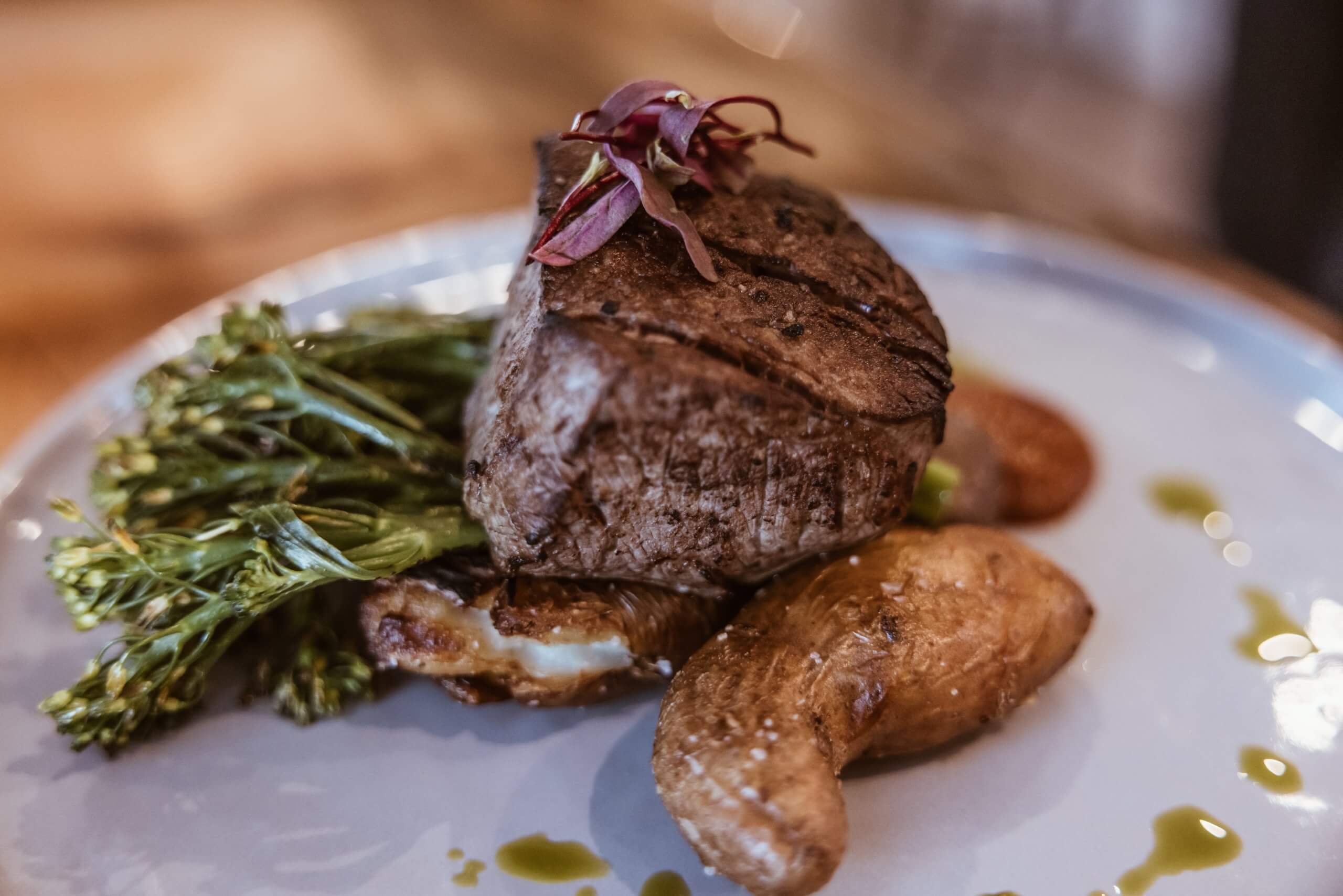 closeup of a steak, potatoes and broccoli