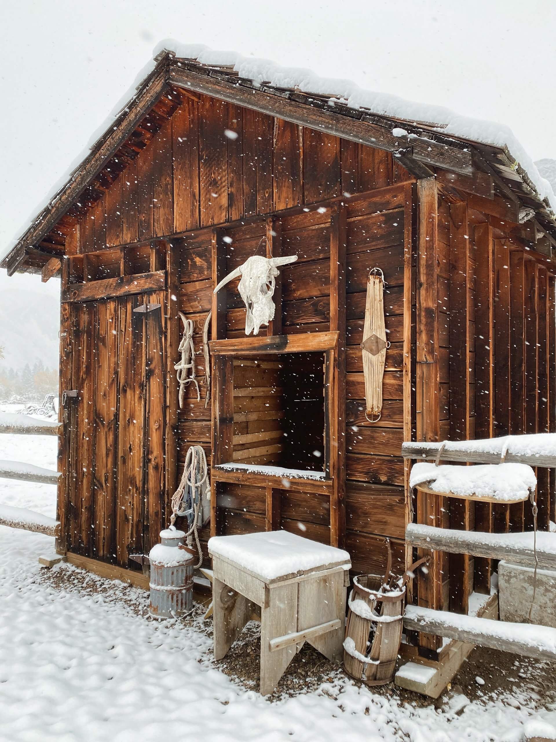 Snowfall dusts the rustic, timber I Bar Ranch Cabin in Challis, Idaho.