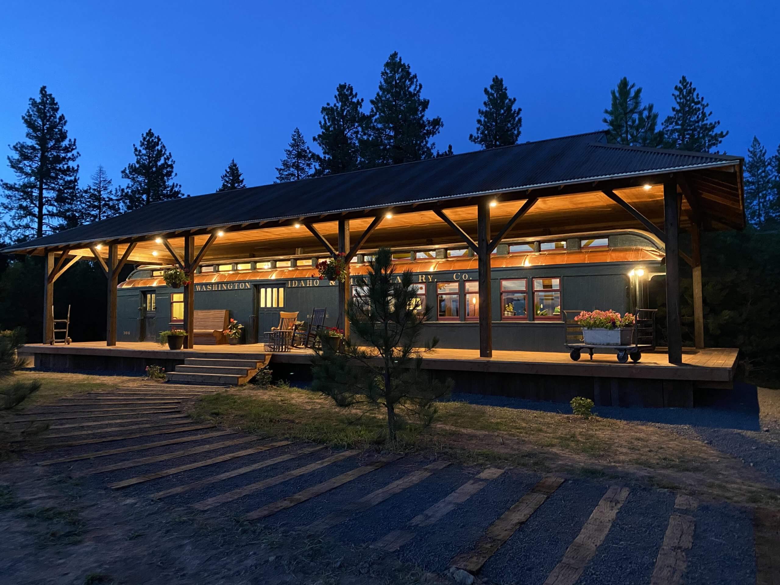 A night view, where the exterior glows of the Restored 1909 Train Carriage.