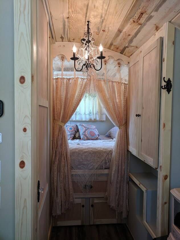 A chandelier hangs inside the stylish interior bedroom of the Salmon Gypsy B&B Wagons.