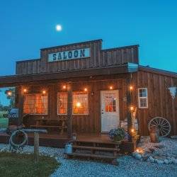 The exterior shines glowing lights outside the Western Saloon in Tetonia at night.