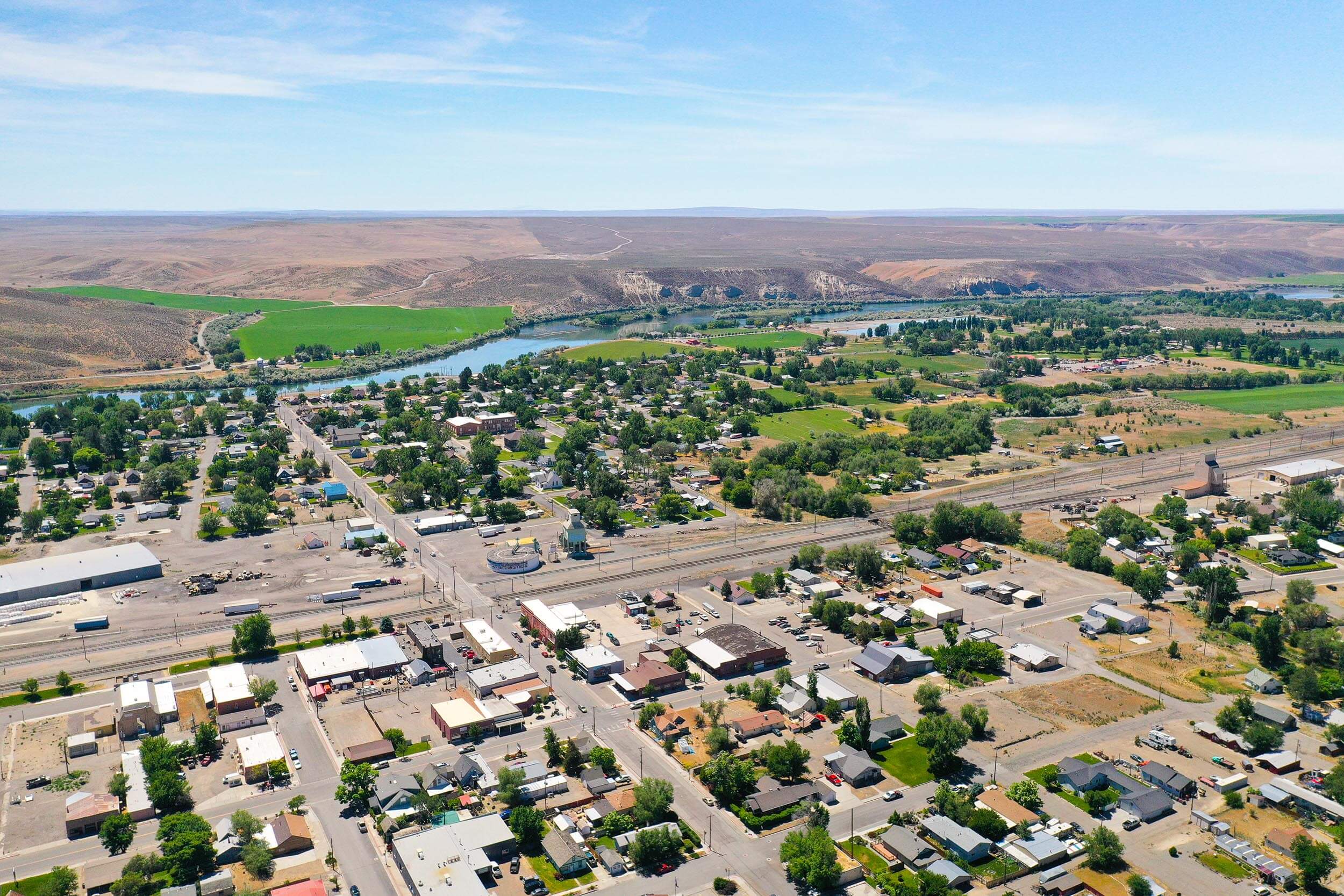 birds-eye view of a town and a river in the distance