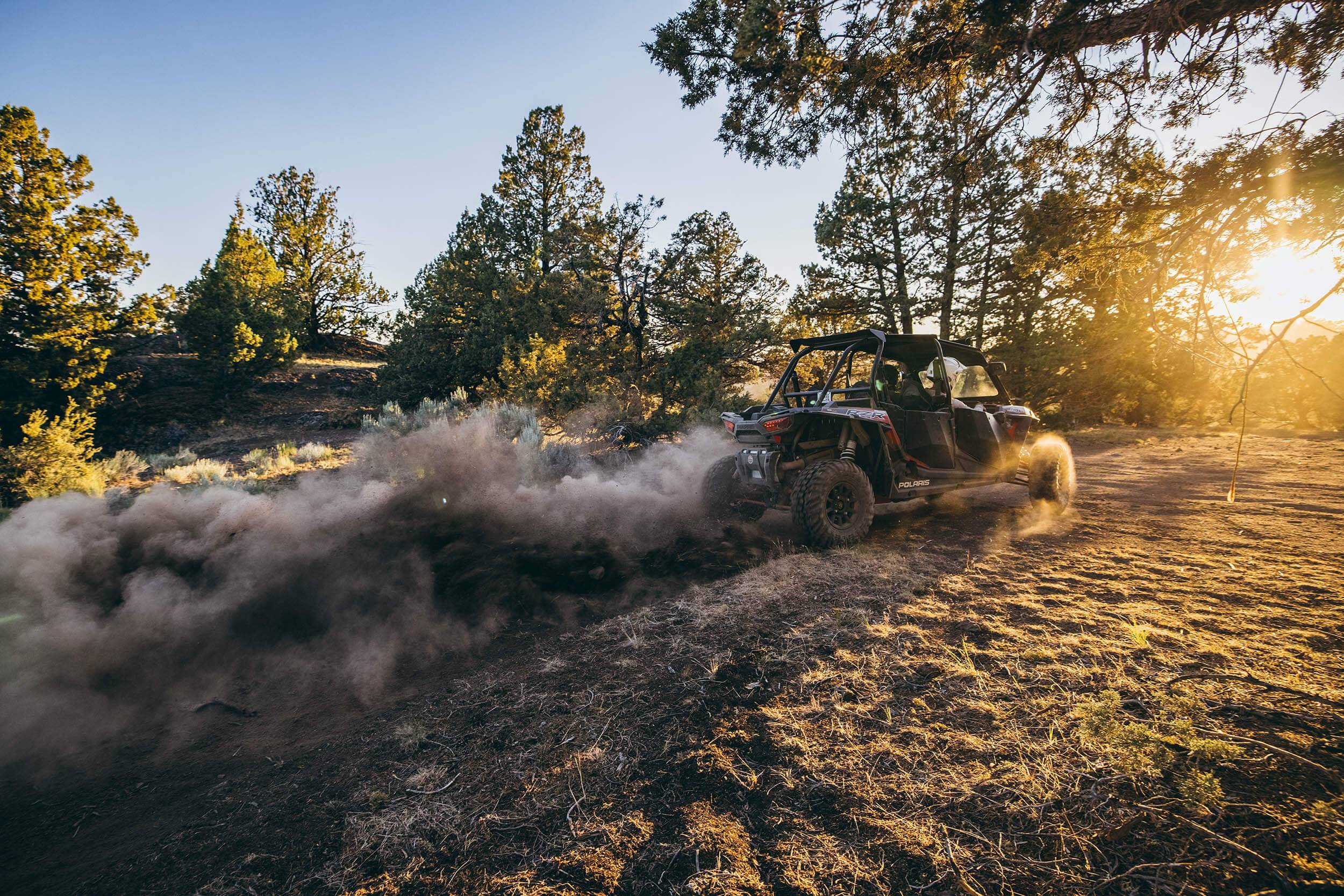 An ATV drives into the sun in the Owyhee Uplands Backcountry.