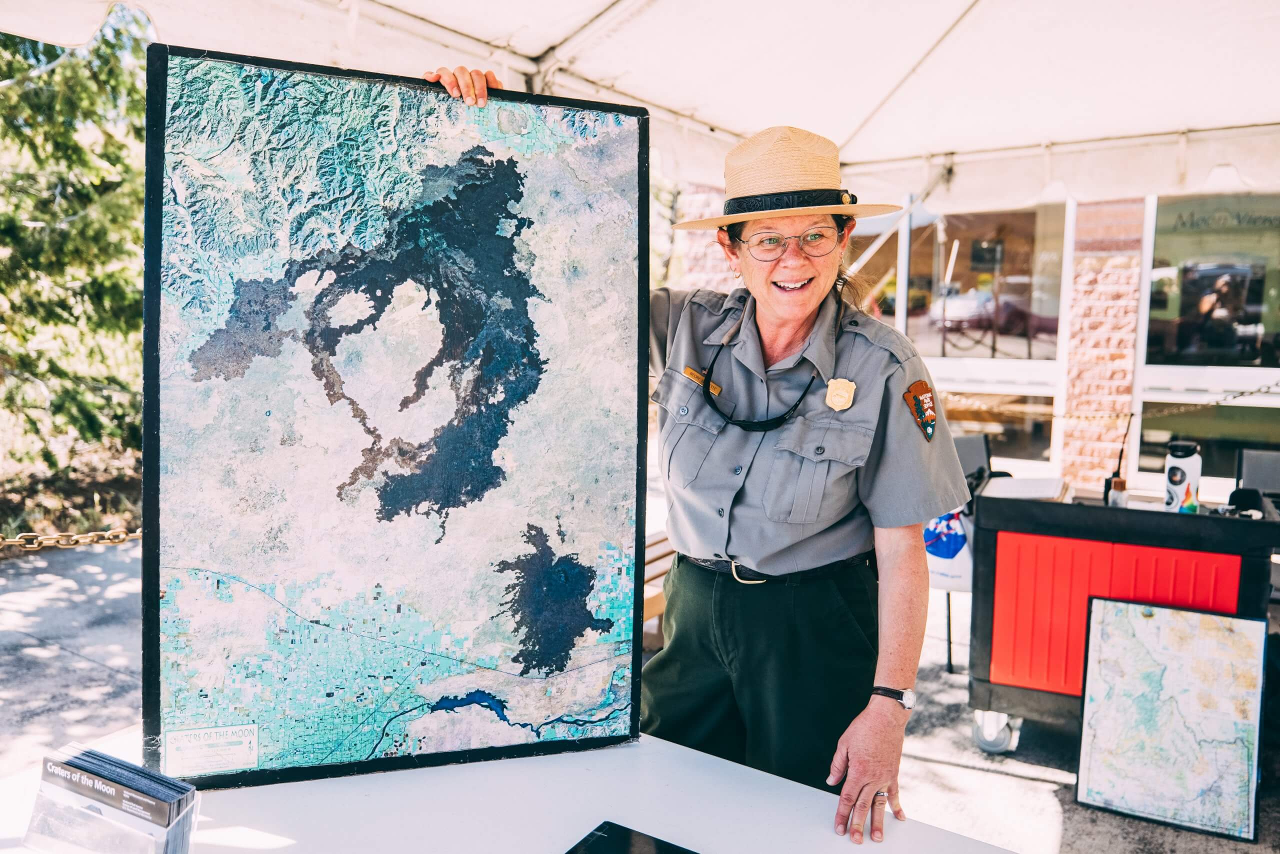 A ranger shows the Craters of the Moon map at the visitors center