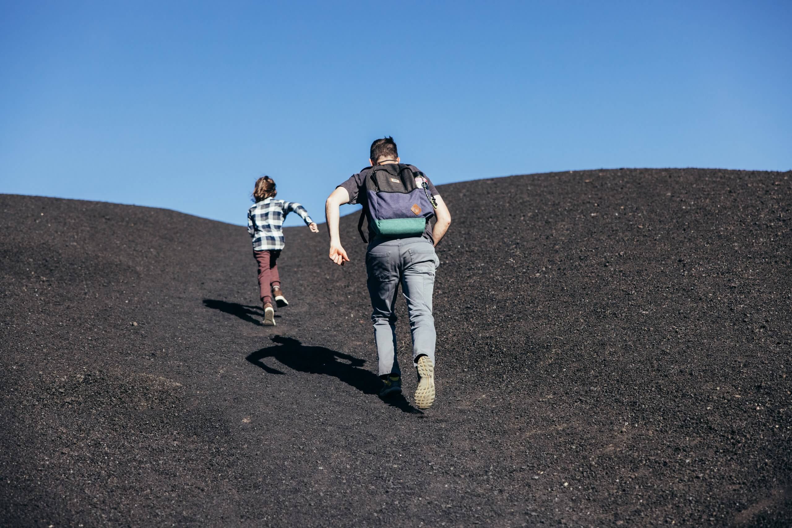 A father and child running up to the Inferno Cone Lookout