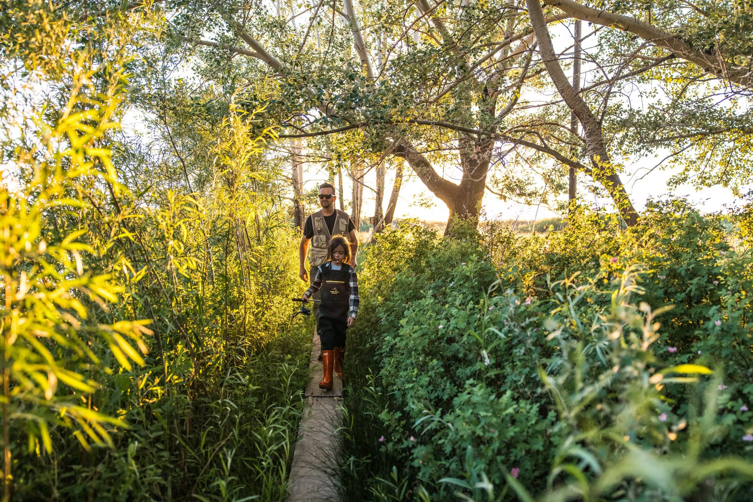 A father and child walking through Silver Creek Preserve