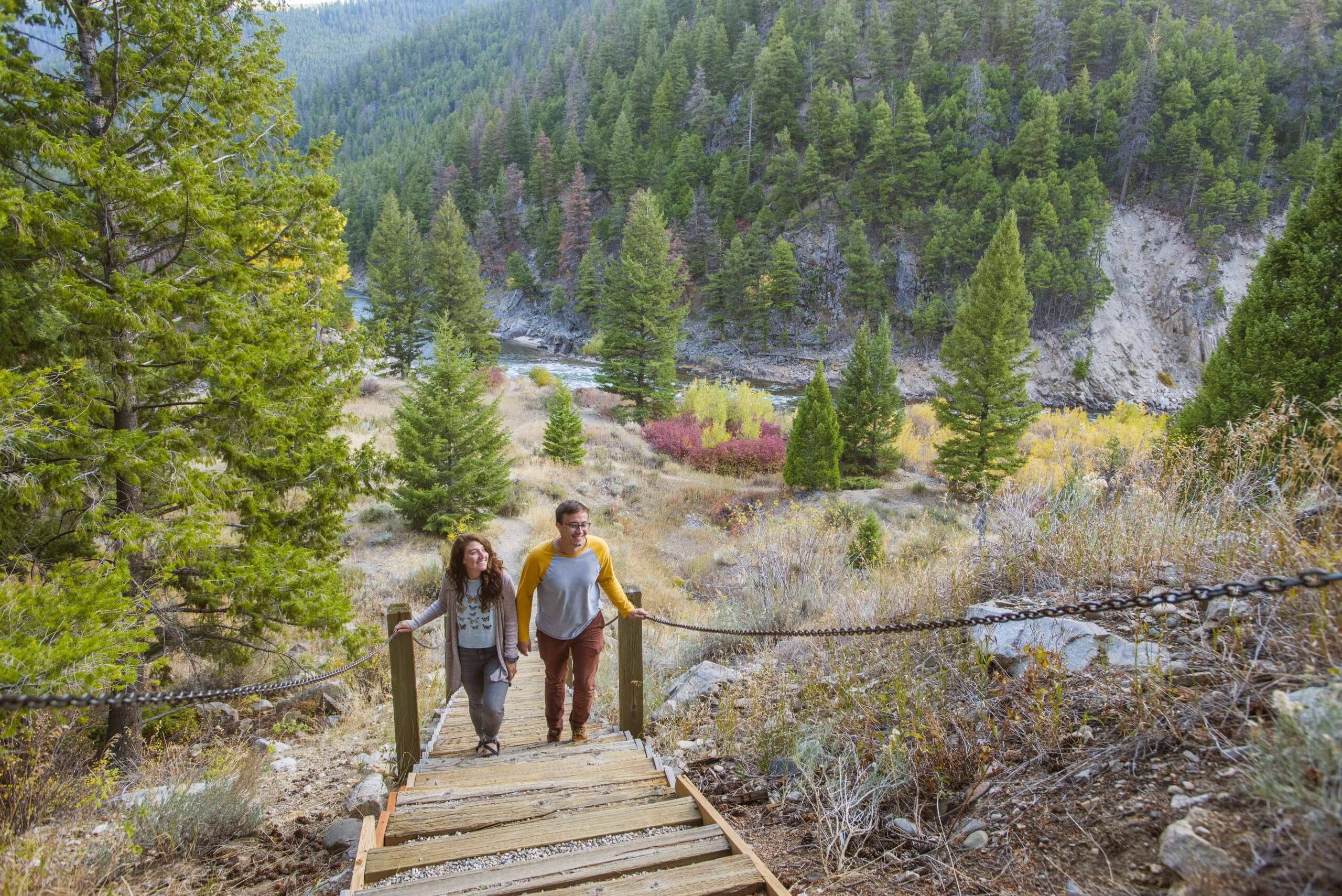 Two visitors walk up stairs outside in Land of the Yankee Fork State Park