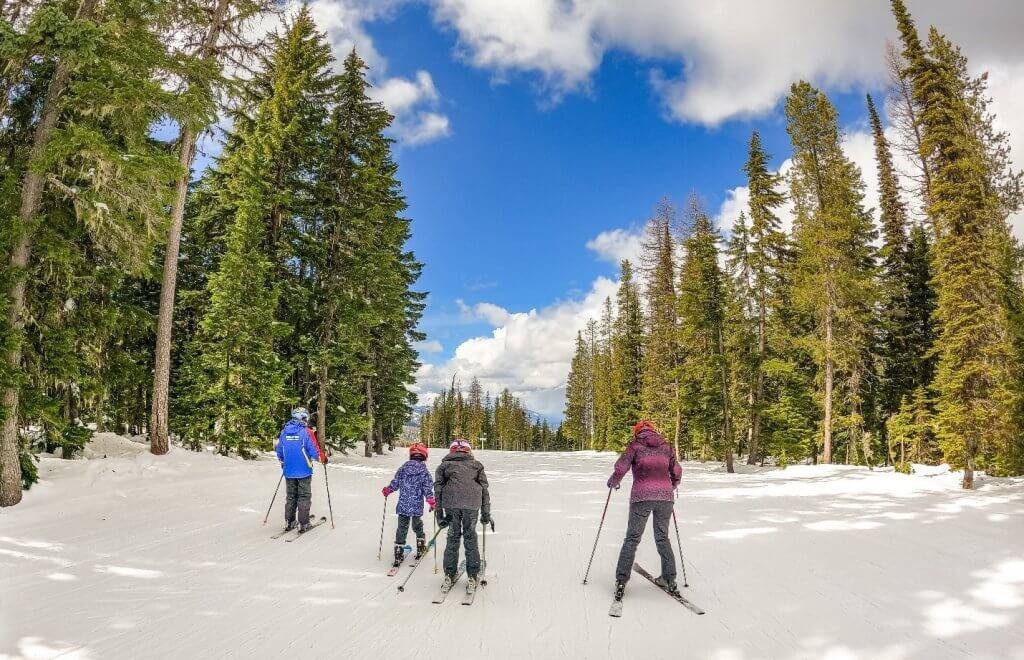 two kids and a mom taking ski lessons