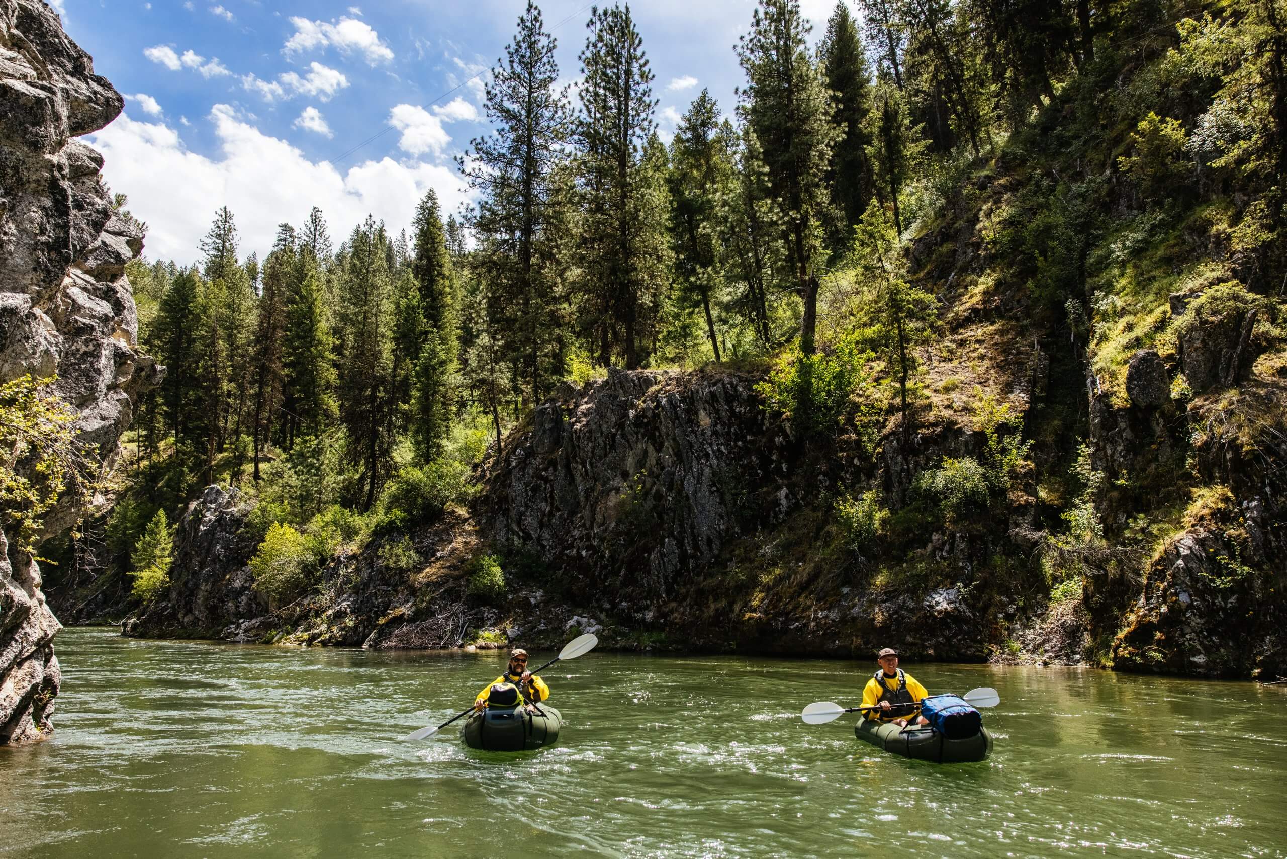 people in inflatable kayaks on a river