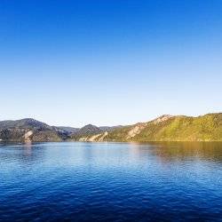 Lake Pend Oreille, surrounded by tree-covered mountains.