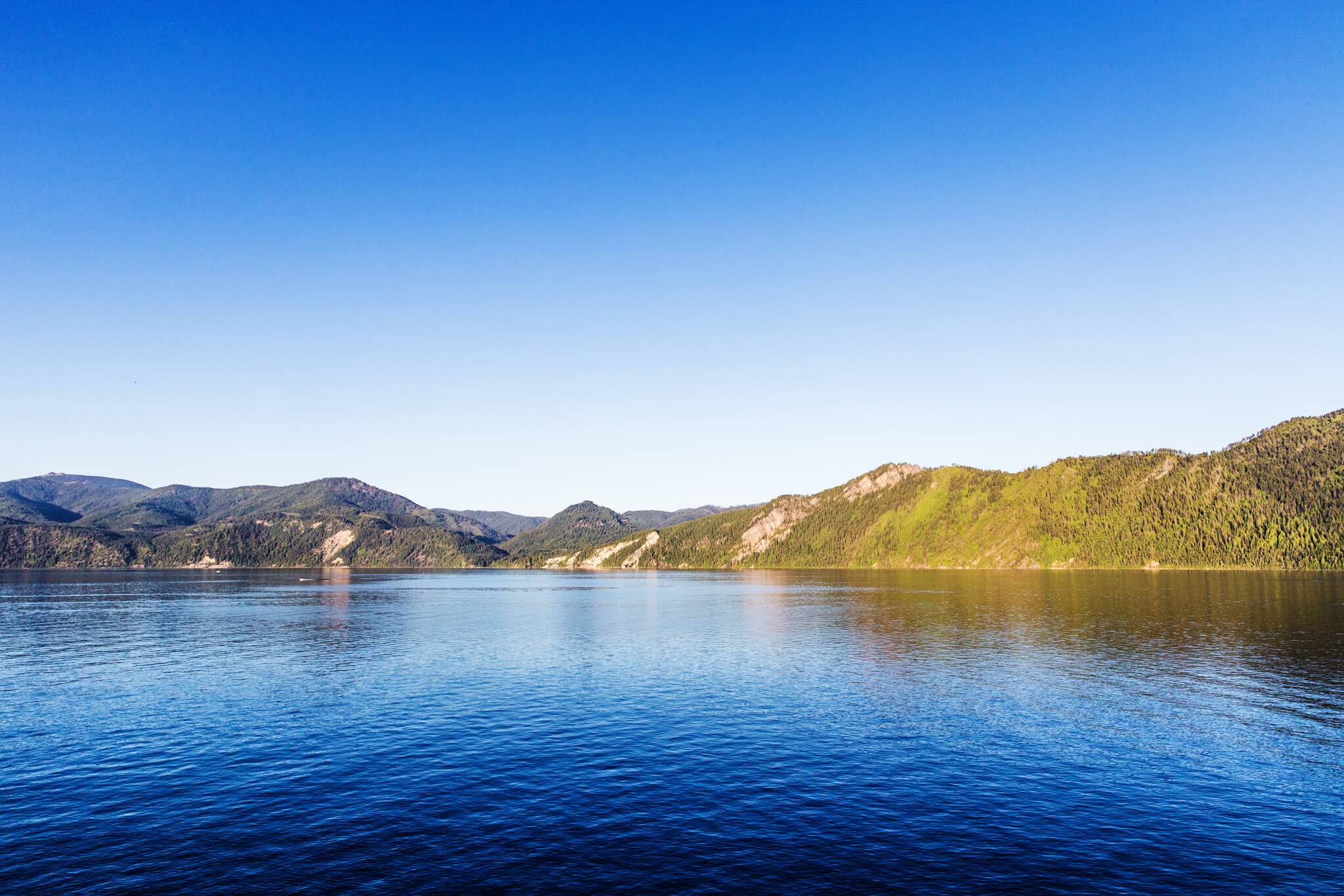 Lake Pend Oreille, surrounded by tree-covered mountains.