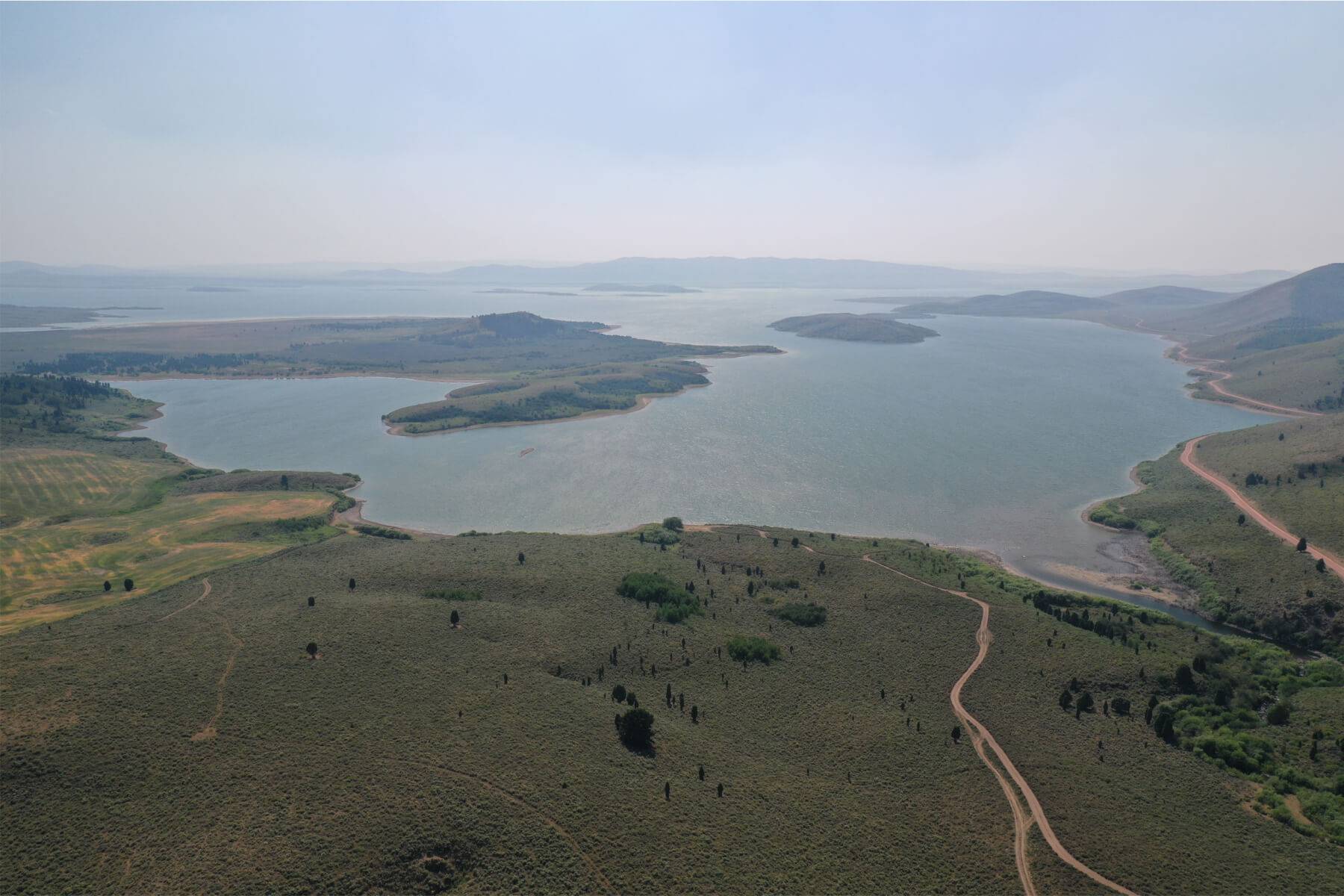 a large reservoir surrounded by green landscape