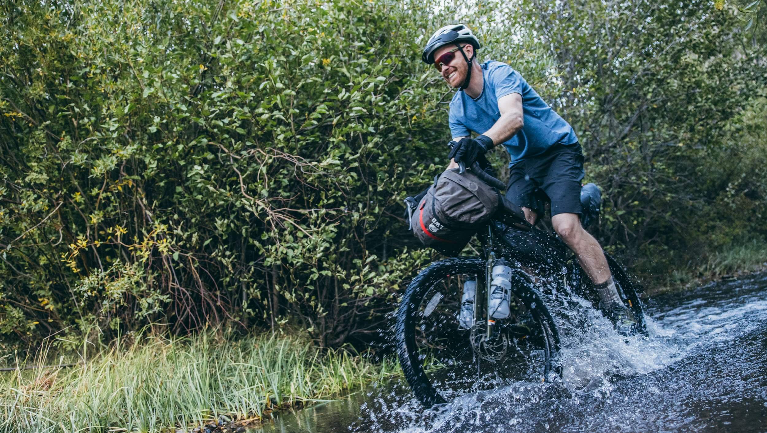 A man rides through a creek near Agency Creek