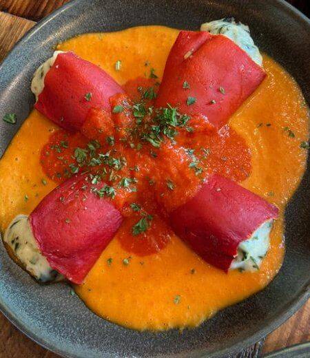 brightly colored plate of piquillo peppers and anchovy filets