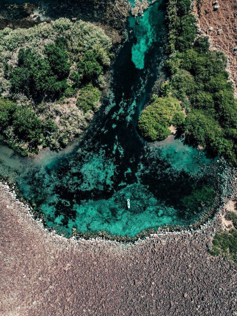 aerial view of blue pool with kayaks inside it